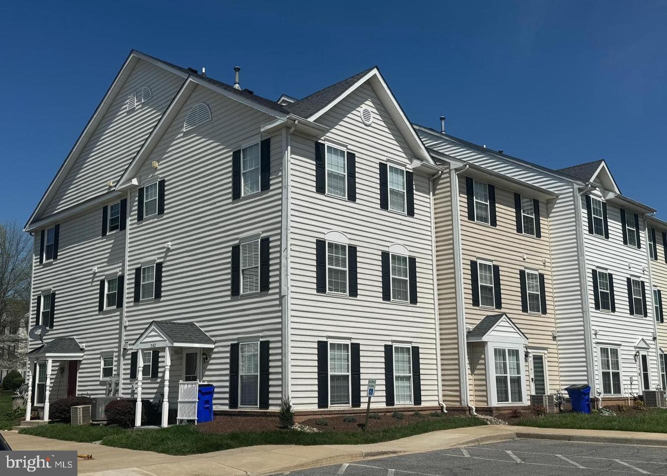 a large white building with a small yard