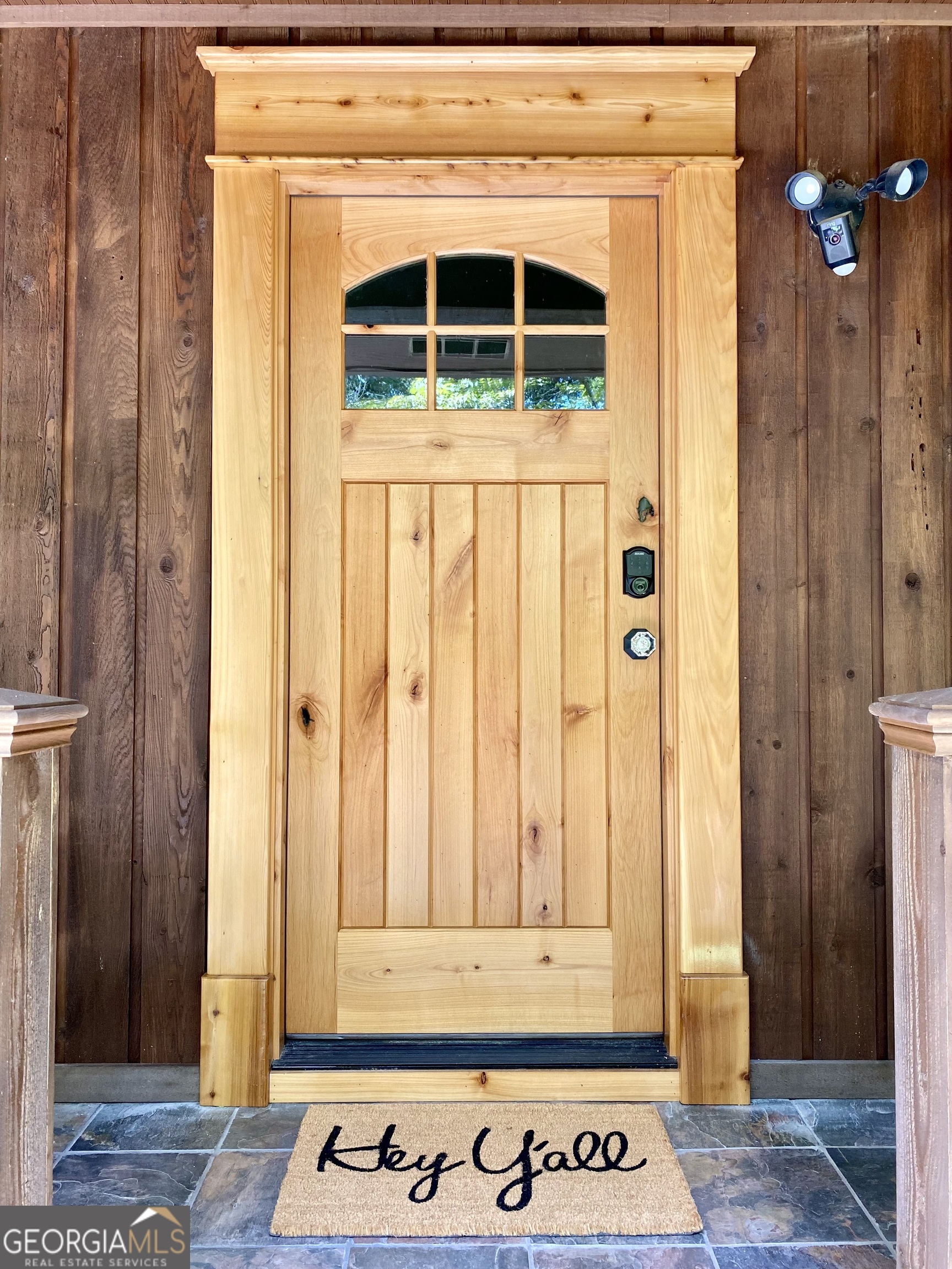 a view of front door with wooden door