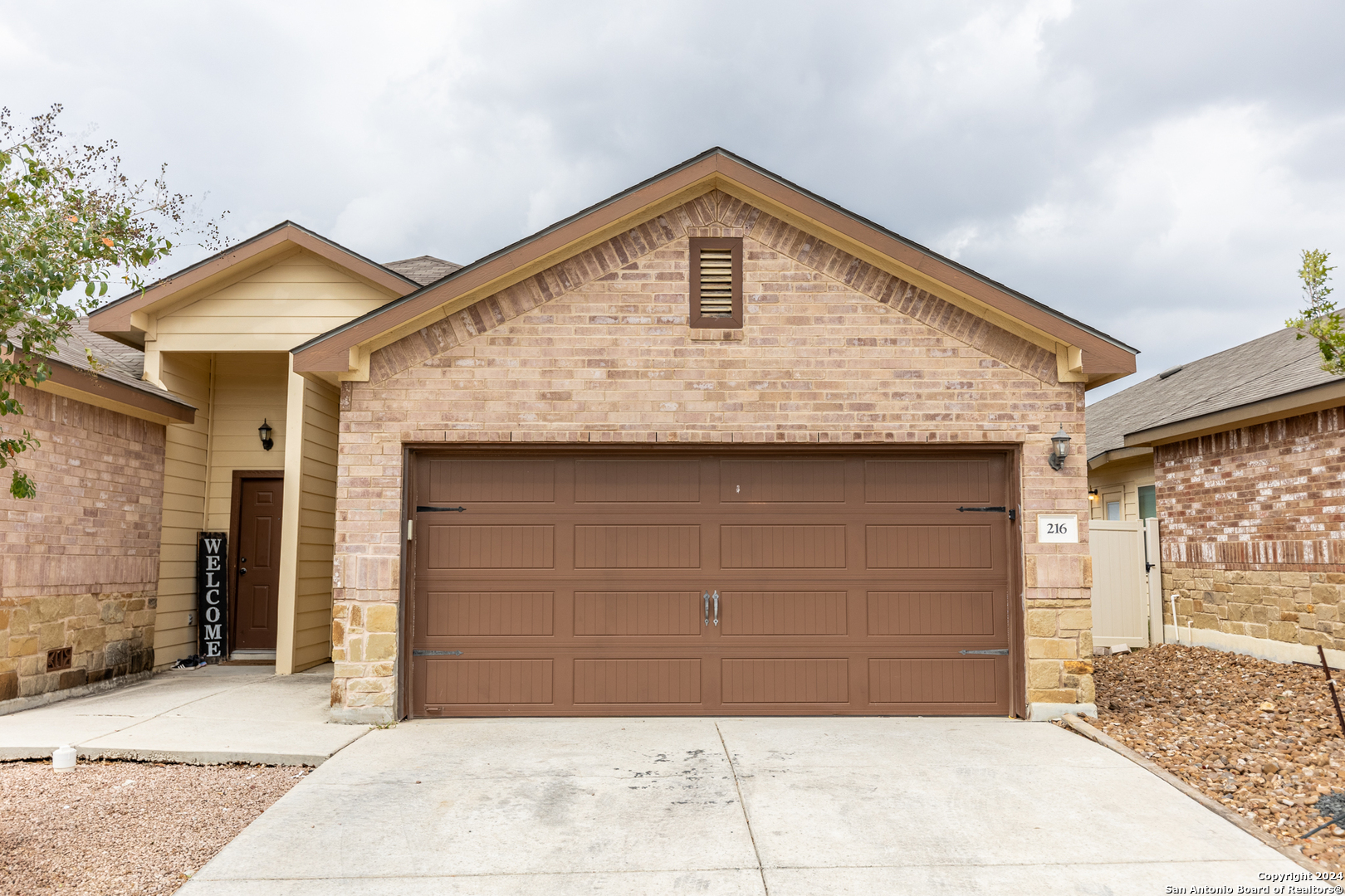 a front view of a house with garage