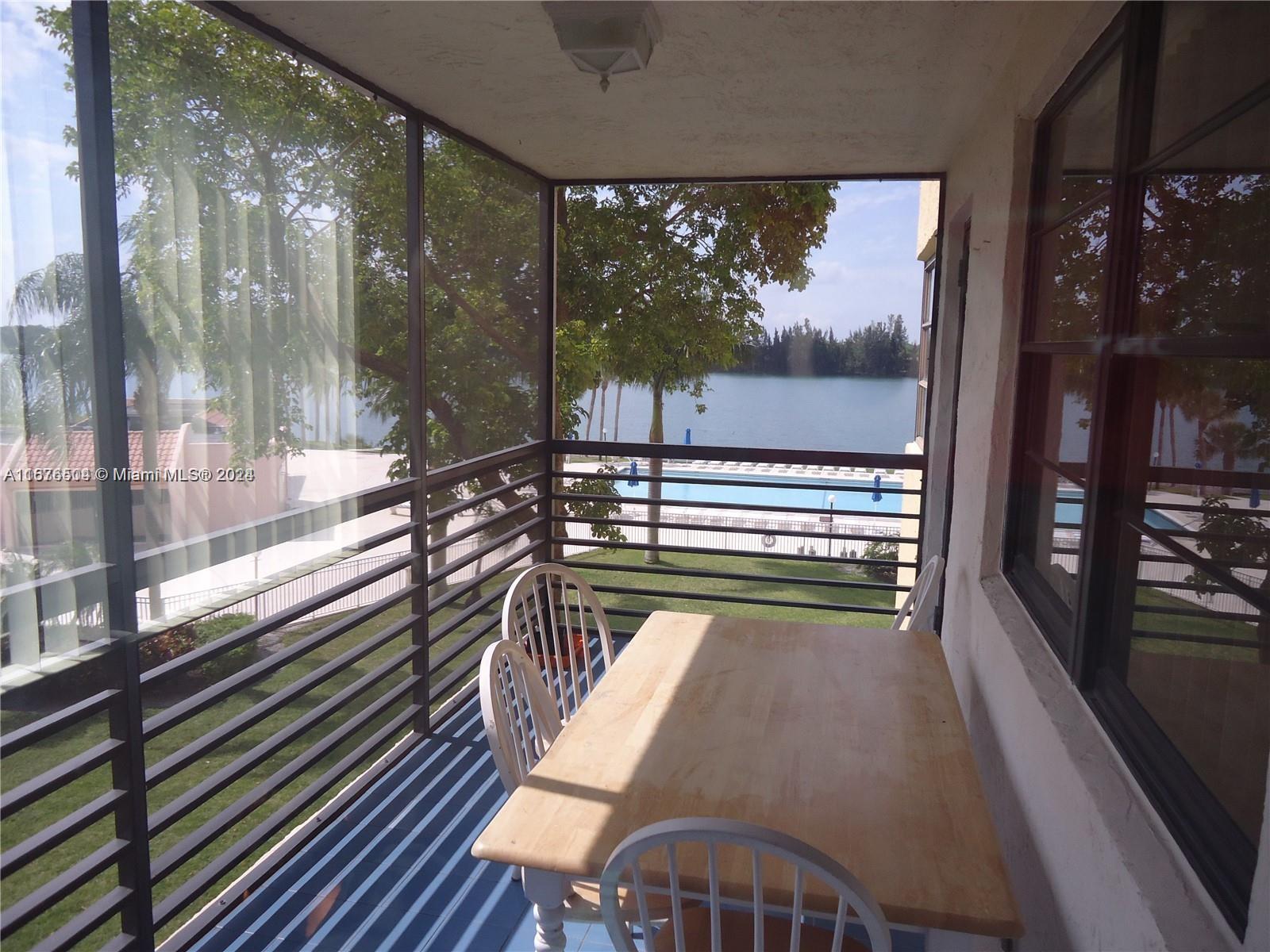 a view of a balcony with wooden floor