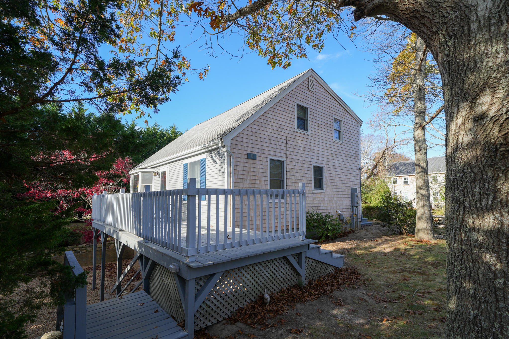 a view of a small house with a yard