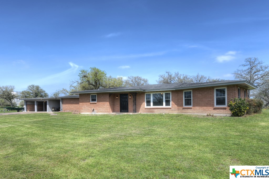 a front view of house with yard and green space