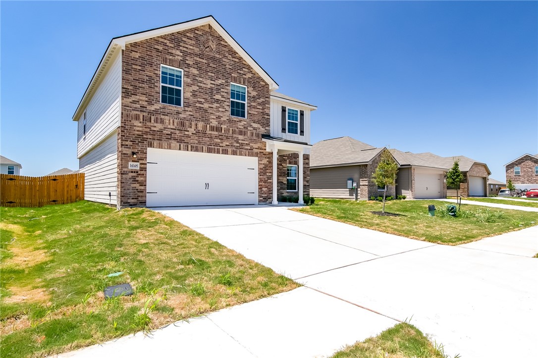 a front view of a house with a yard