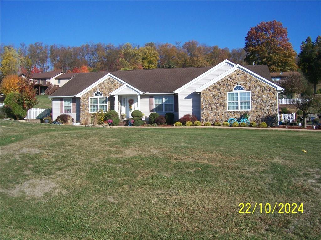 a front view of house with yard and green space