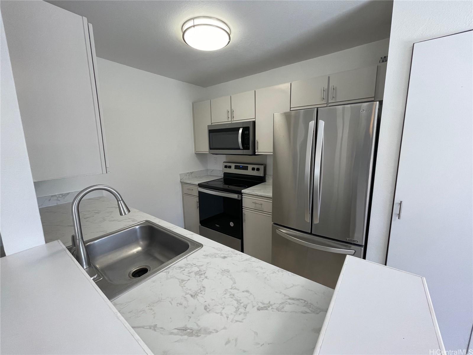 a kitchen with stainless steel appliances a refrigerator and a sink