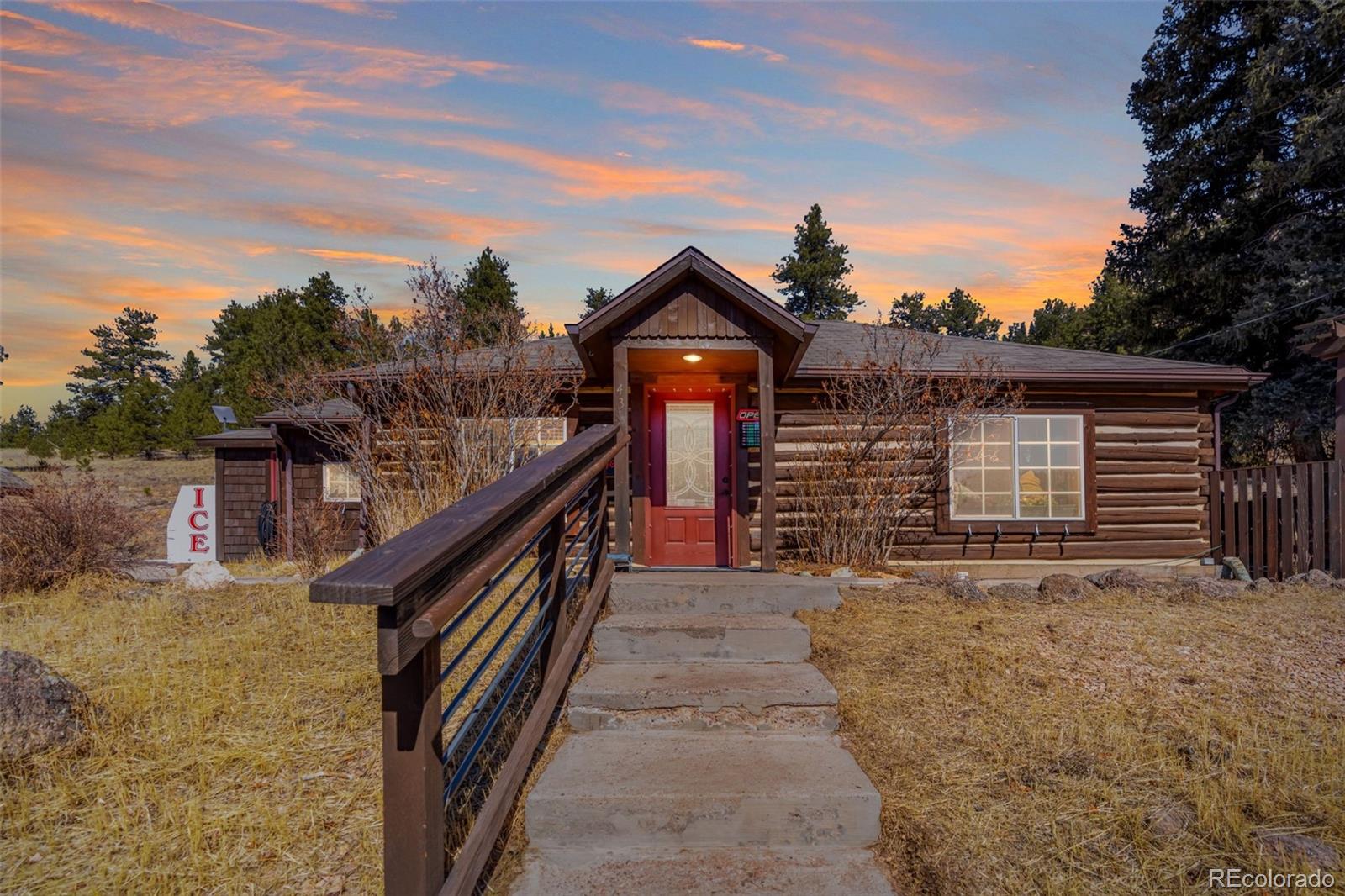 a view of a house with wooden fence