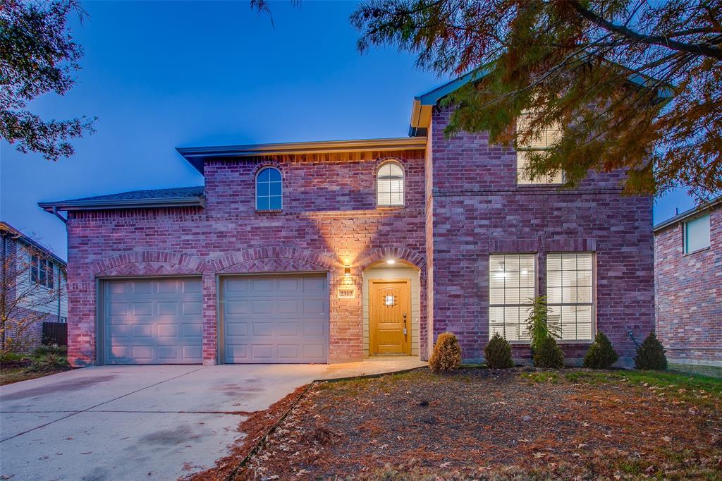 View of front facade featuring a garage