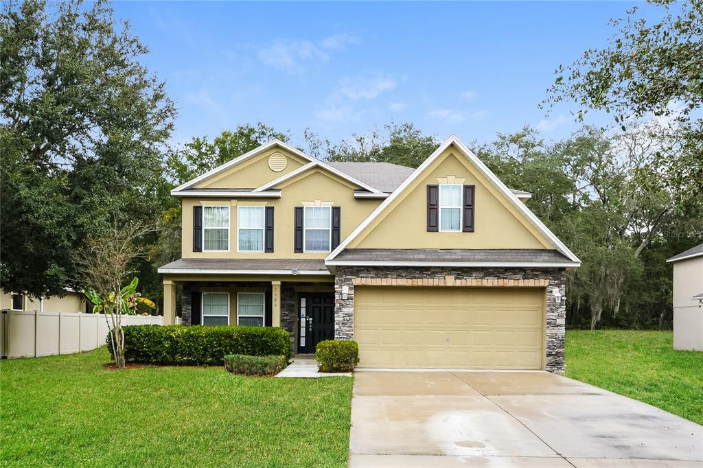 a front view of a house with a yard and garage