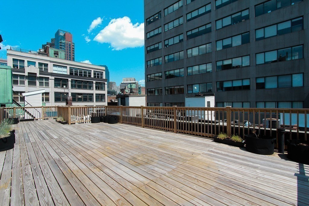 a view of a balcony with wooden floor and city view