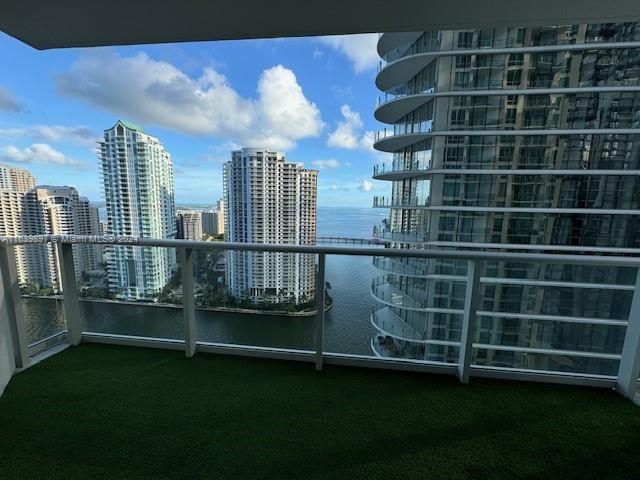 a view of a balcony with wooden floor and pool