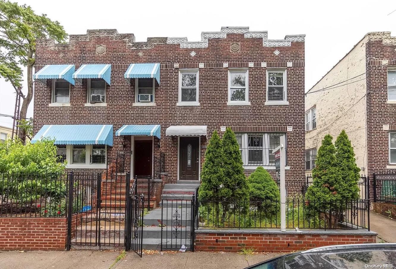 a view of a brick building next to a yard