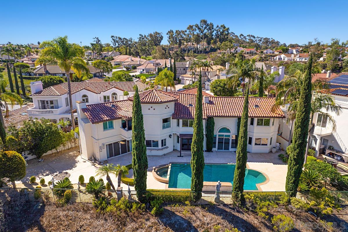 an aerial view of multiple houses with a yard