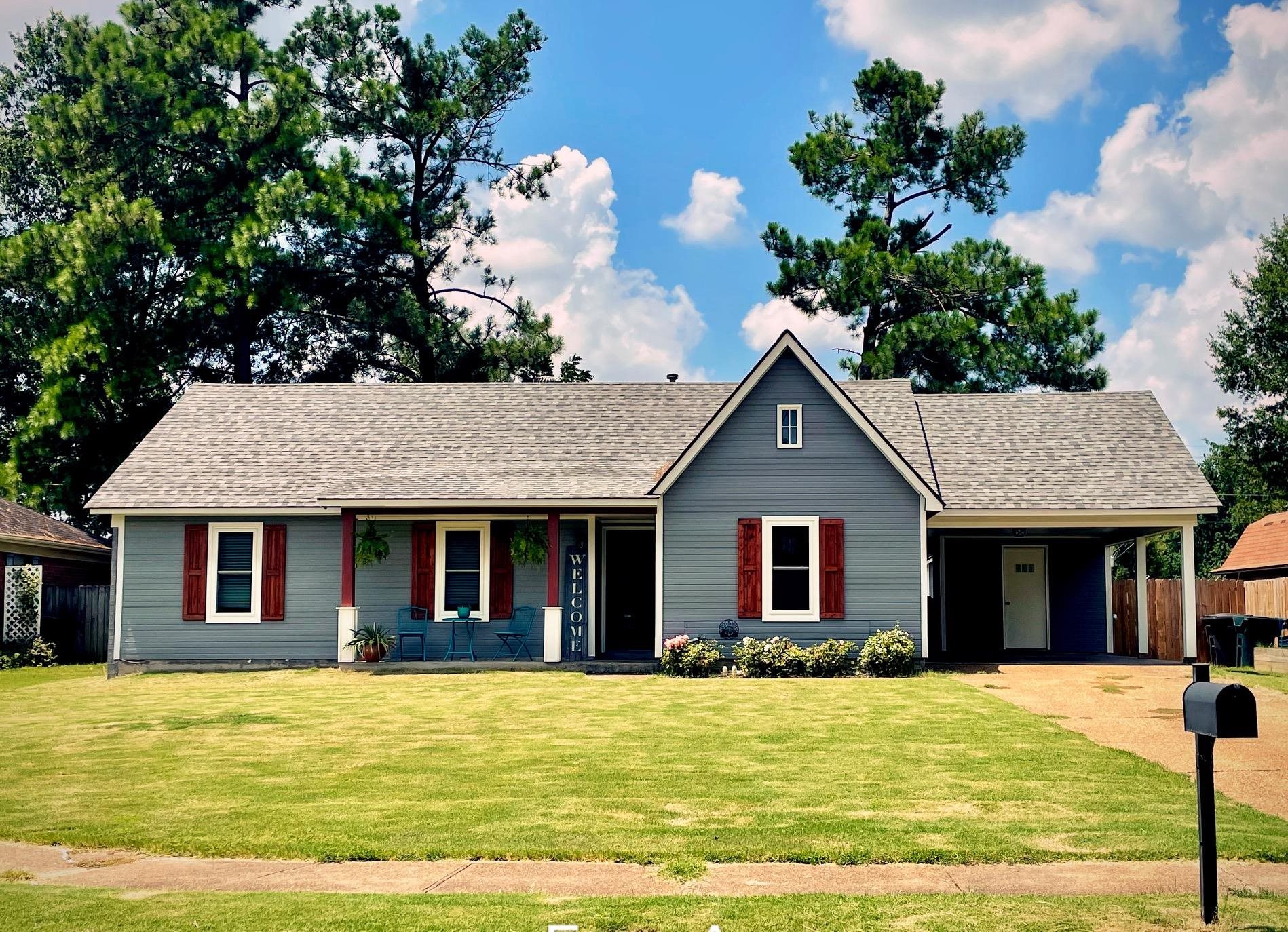 Ranch-style house with a front lawn and a carport