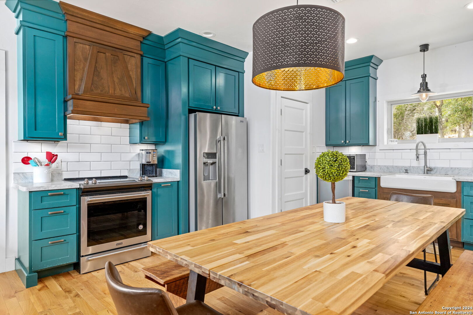 a kitchen with a table chairs and a refrigerator