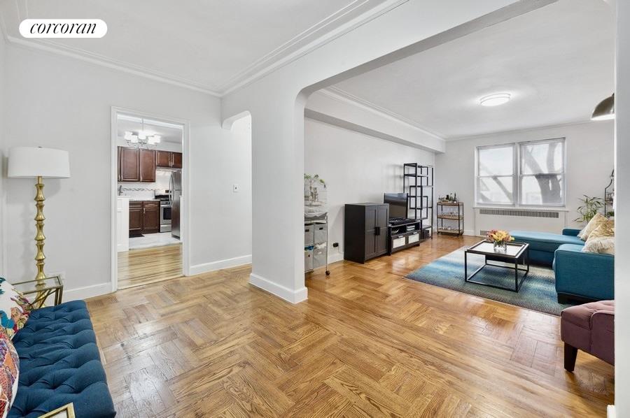 a living room with furniture and a kitchen