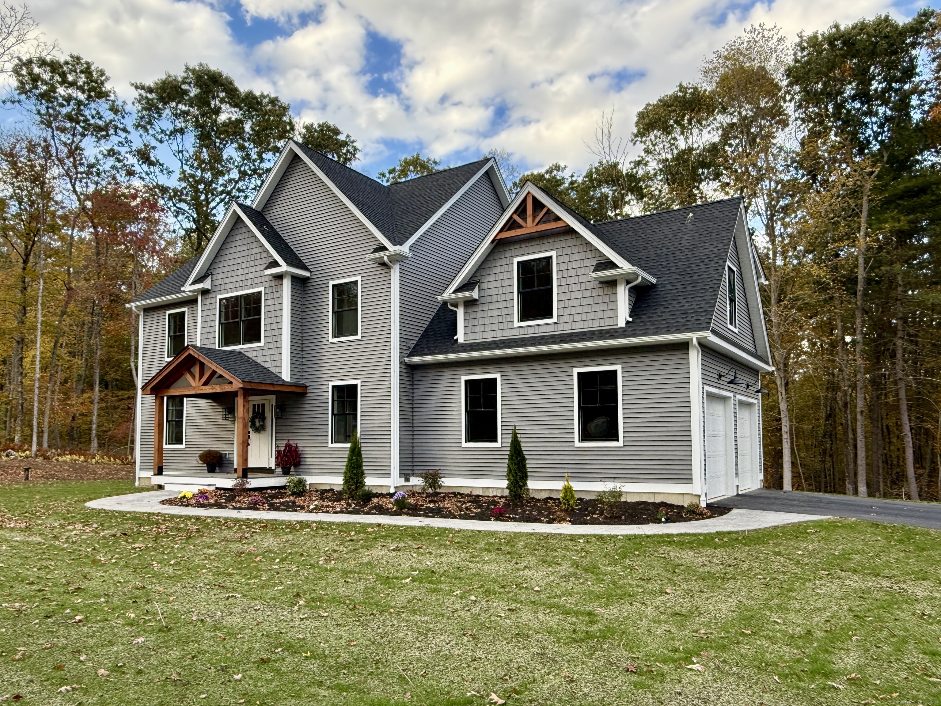 a front view of house with yard and green space