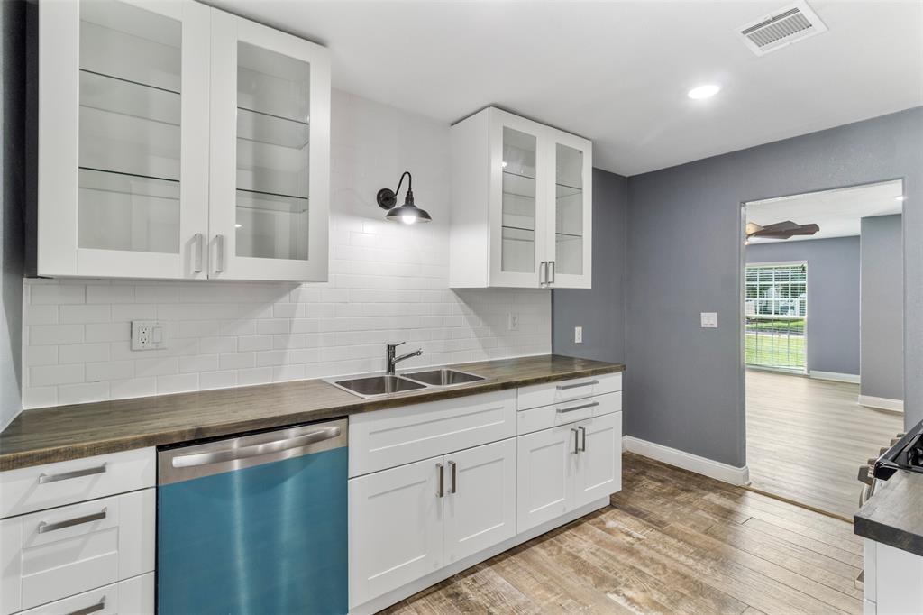 a kitchen with stainless steel appliances granite countertop a sink and cabinets