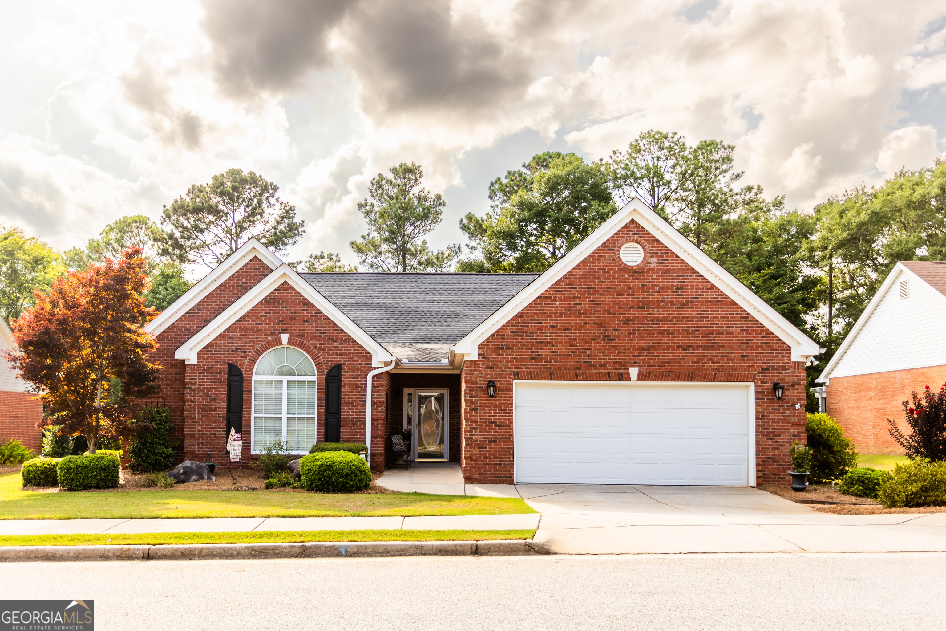 a view of house with yard outdoor seating and barbeque oven