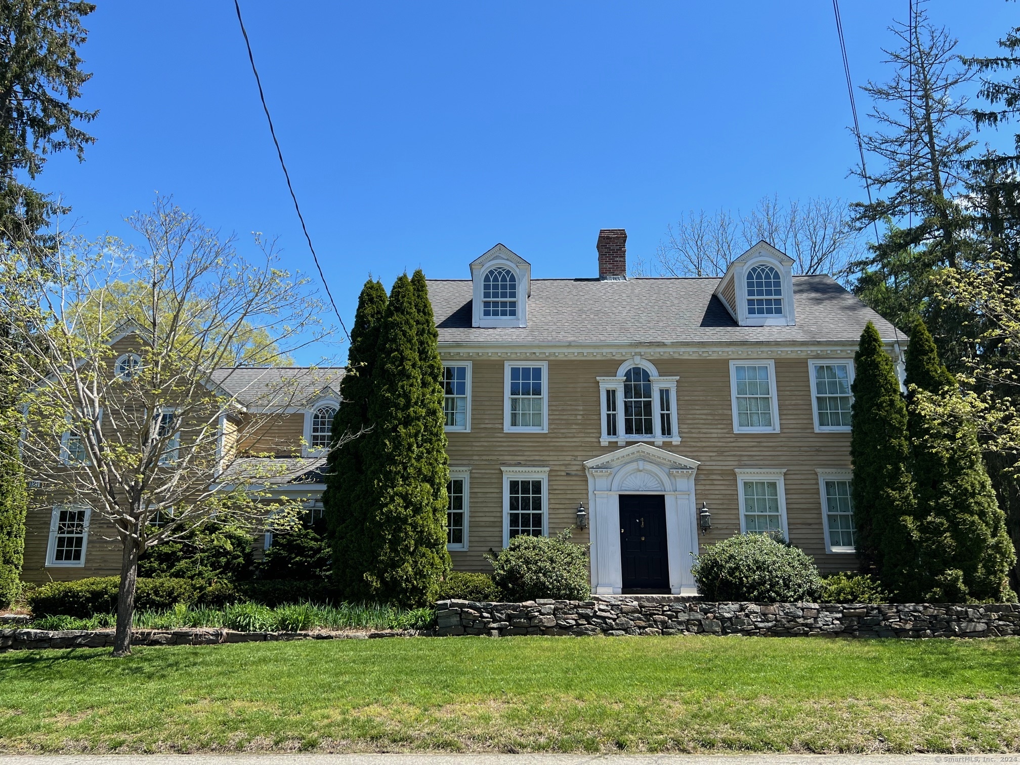 a front view of house with yard and green space