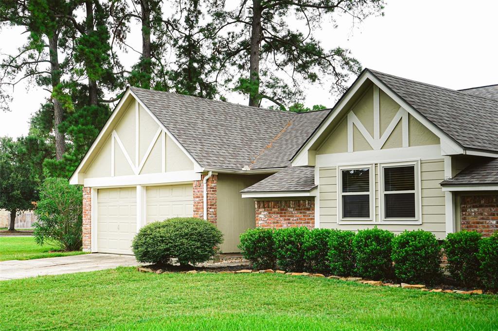 a front view of a house with a yard and green space