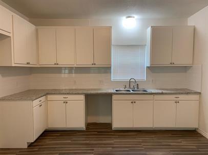 a kitchen with stainless steel appliances granite countertop a sink stove and cabinets