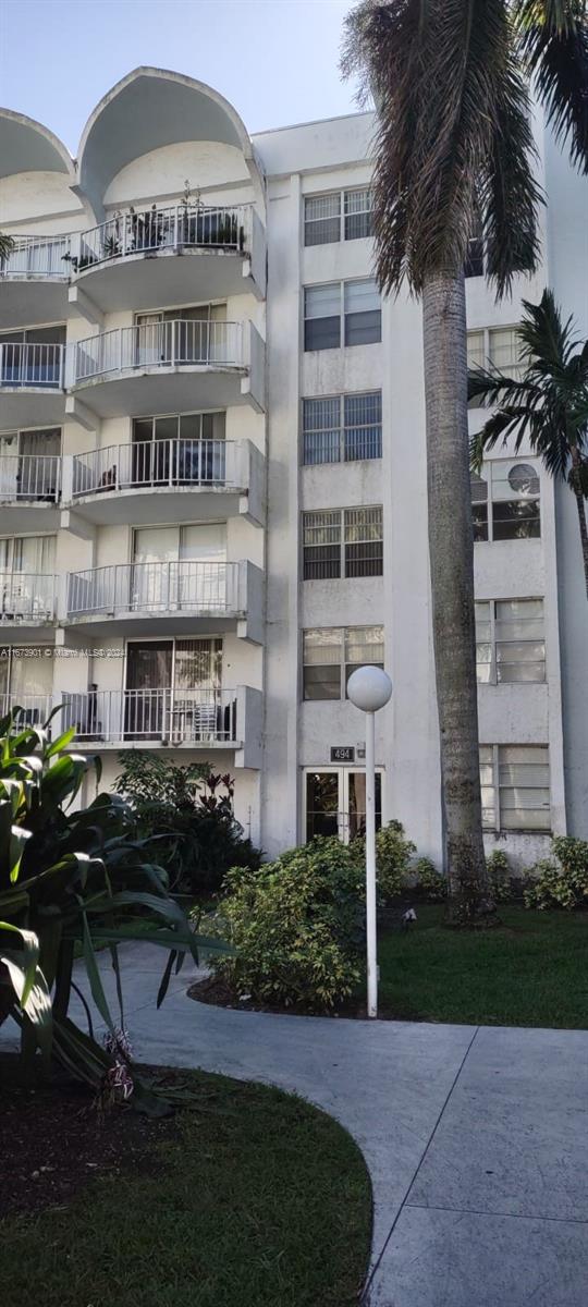 a front view of a residential apartment building with a yard