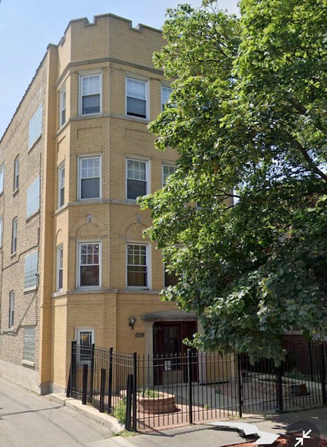 a front view of a building with a garden