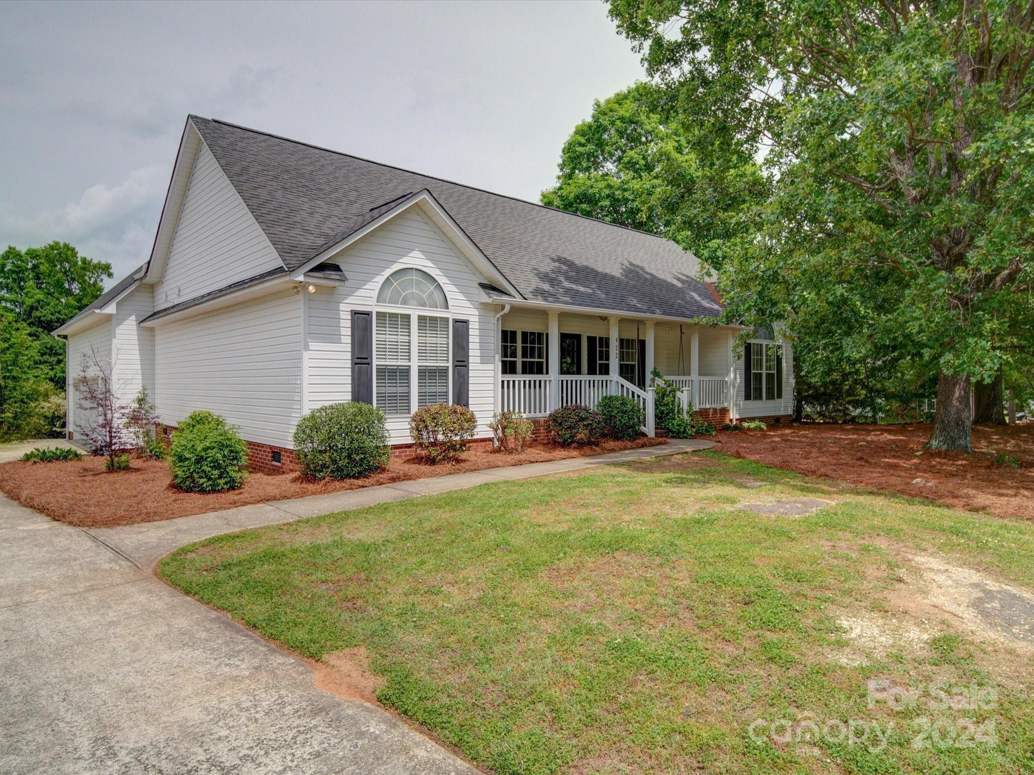 a front view of a house with yard patio and green space