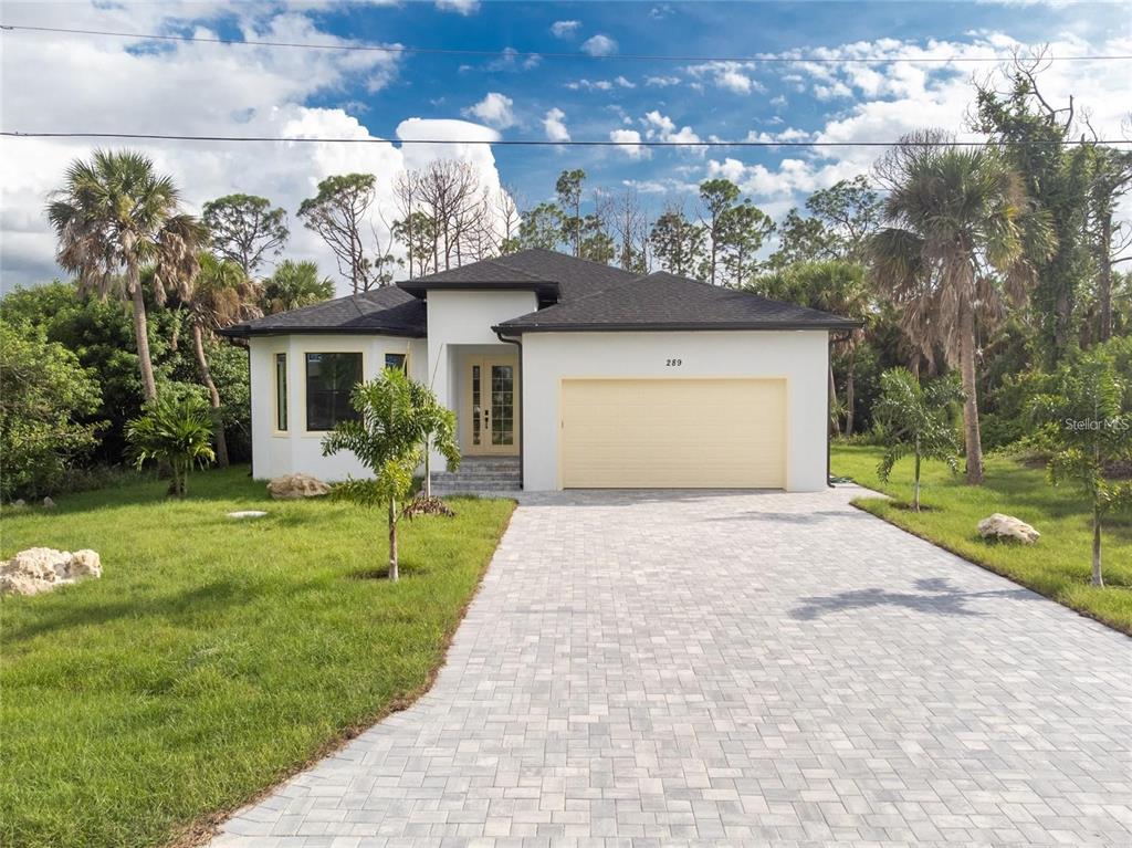 a front view of a house with a yard and garage