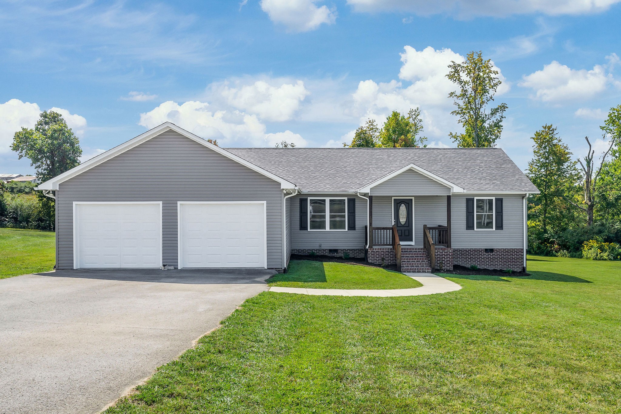 a front view of a house with yard and garage