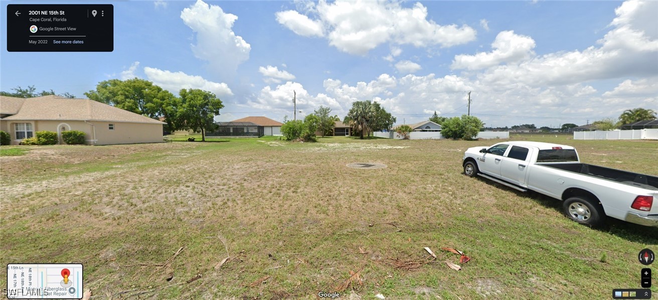 a view of yard with car parked