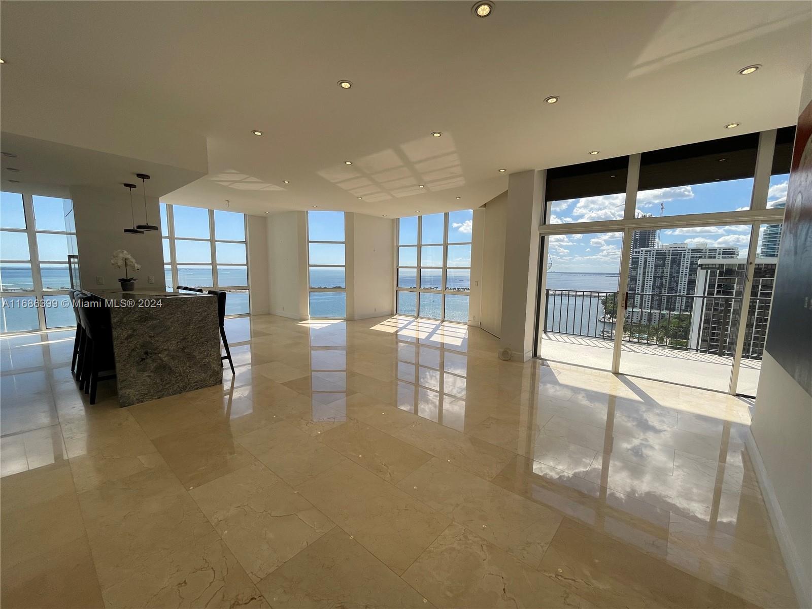 a lobby with furniture and floor to ceiling window