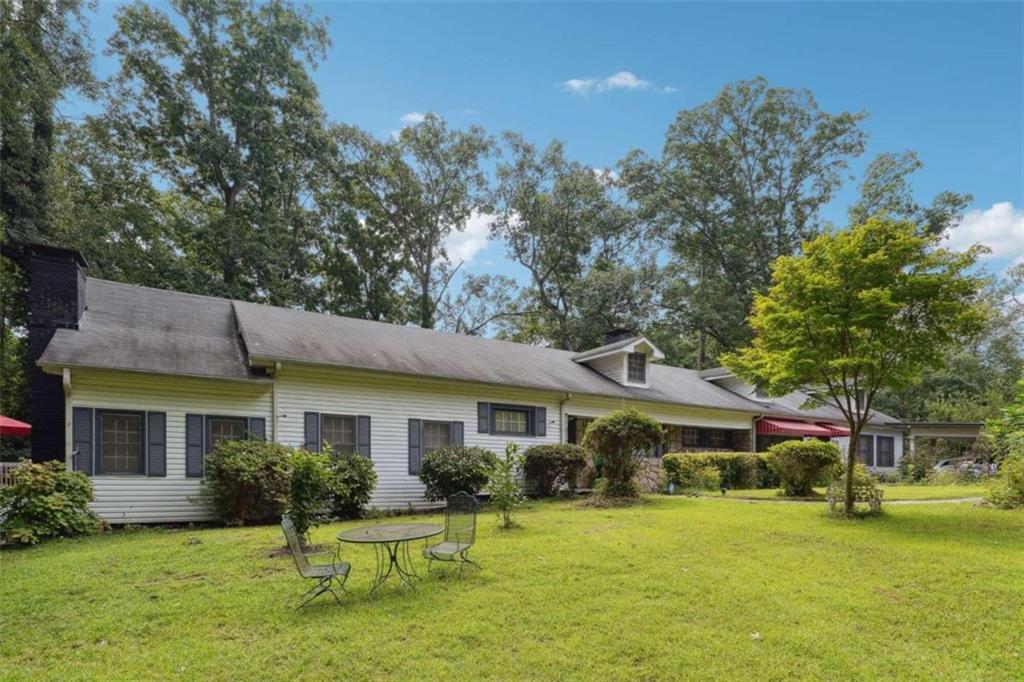 a front view of house with yard and green space