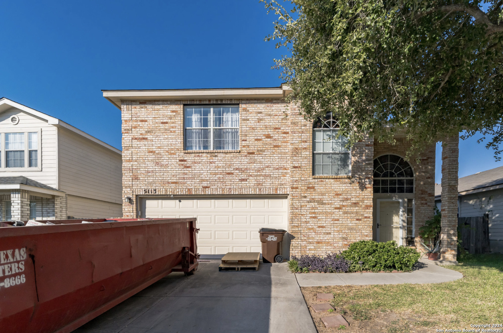 a front view of a house with parking area