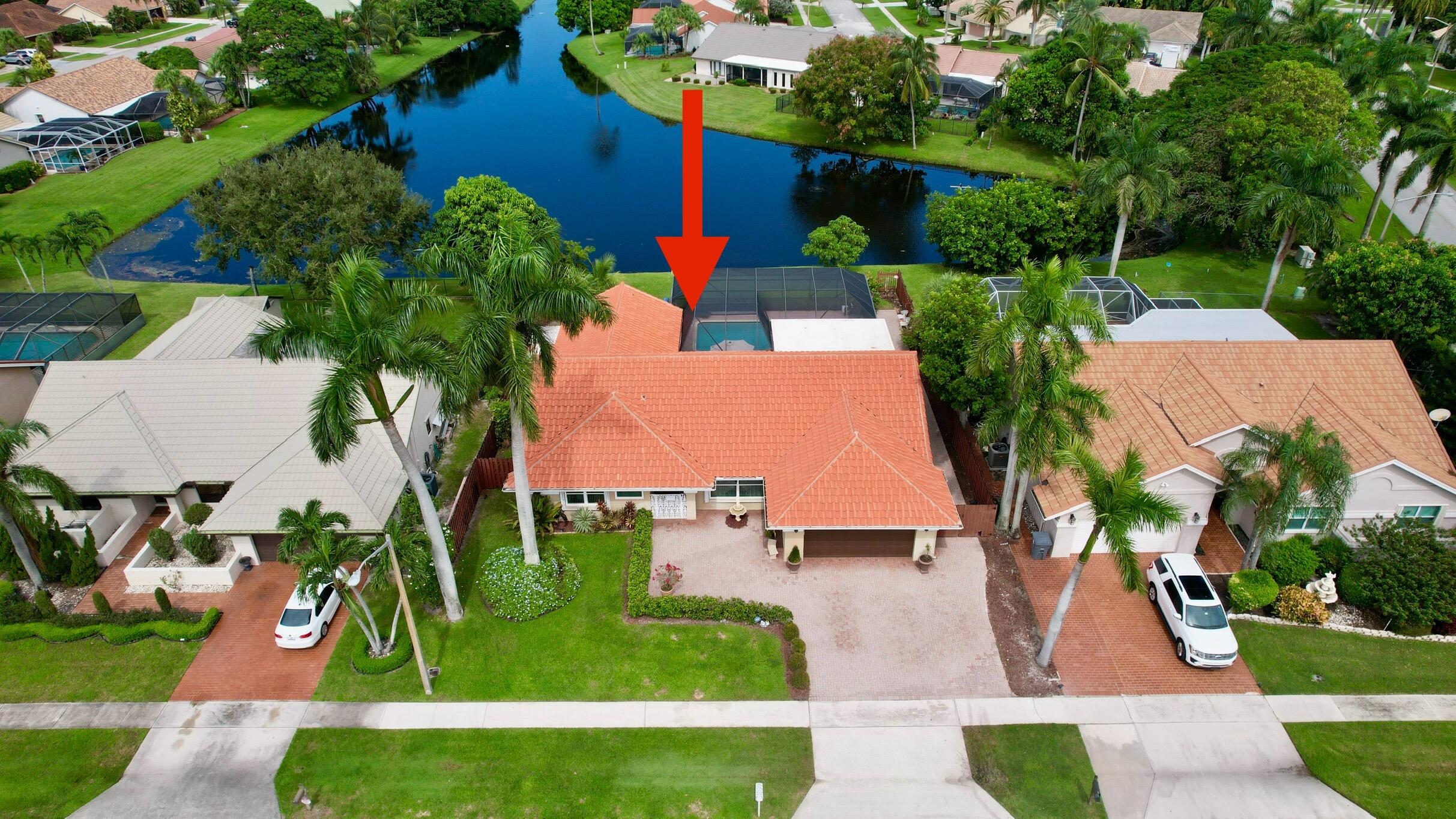 an aerial view of a house with a yard and potted plants