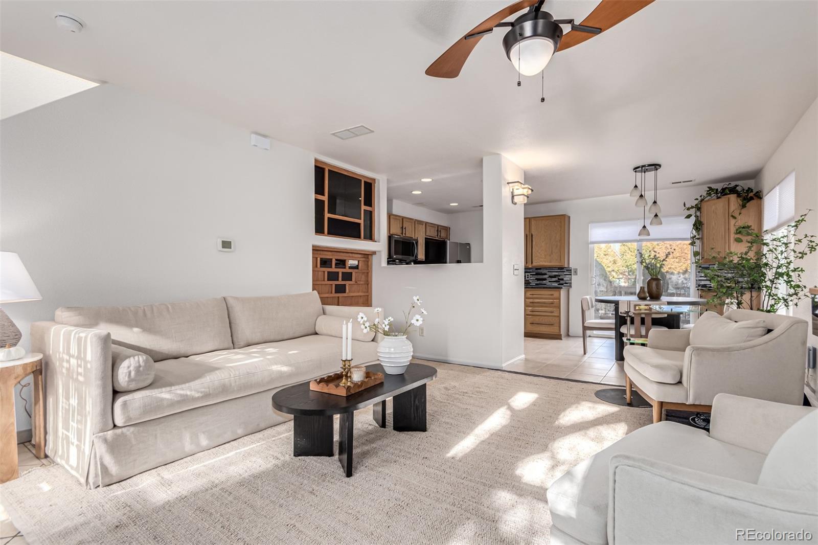 a living room with furniture and kitchen view