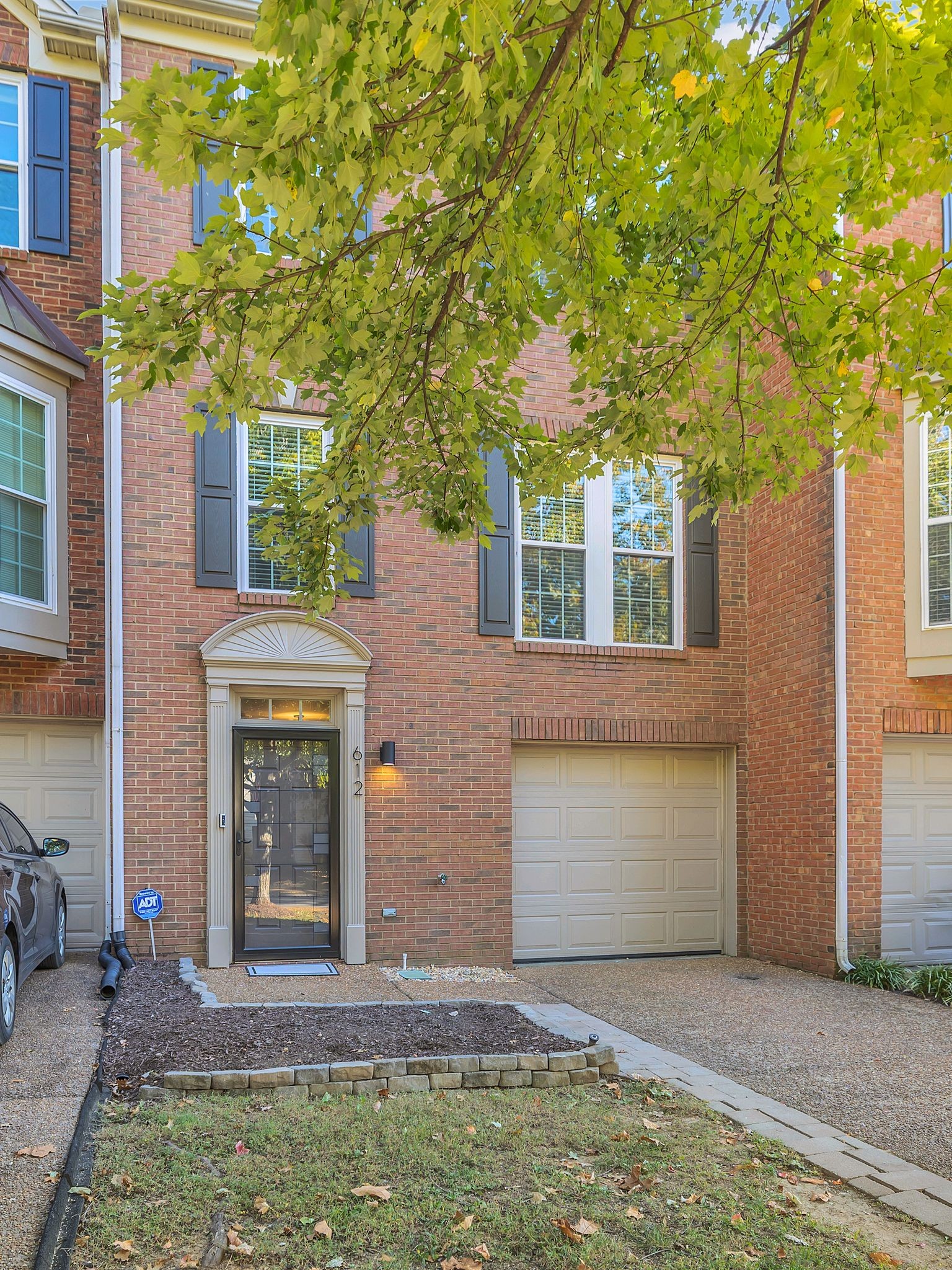 a front view of a house with a yard garage and outdoor seating