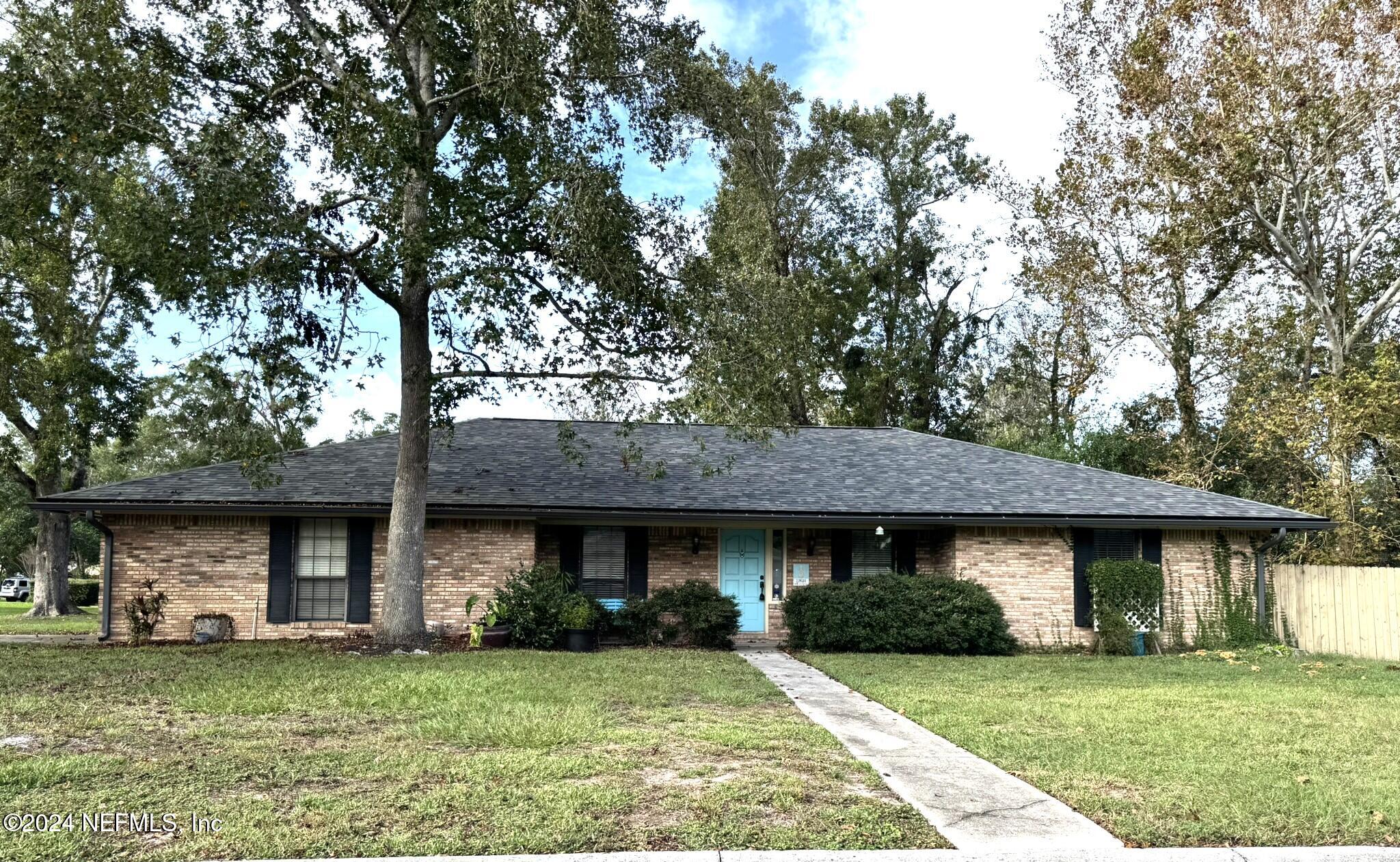 a view of a brick house with a big yard