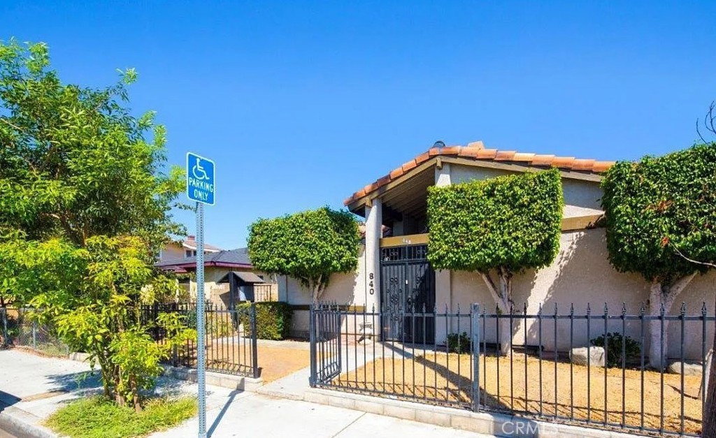 a view of a house with wooden fence