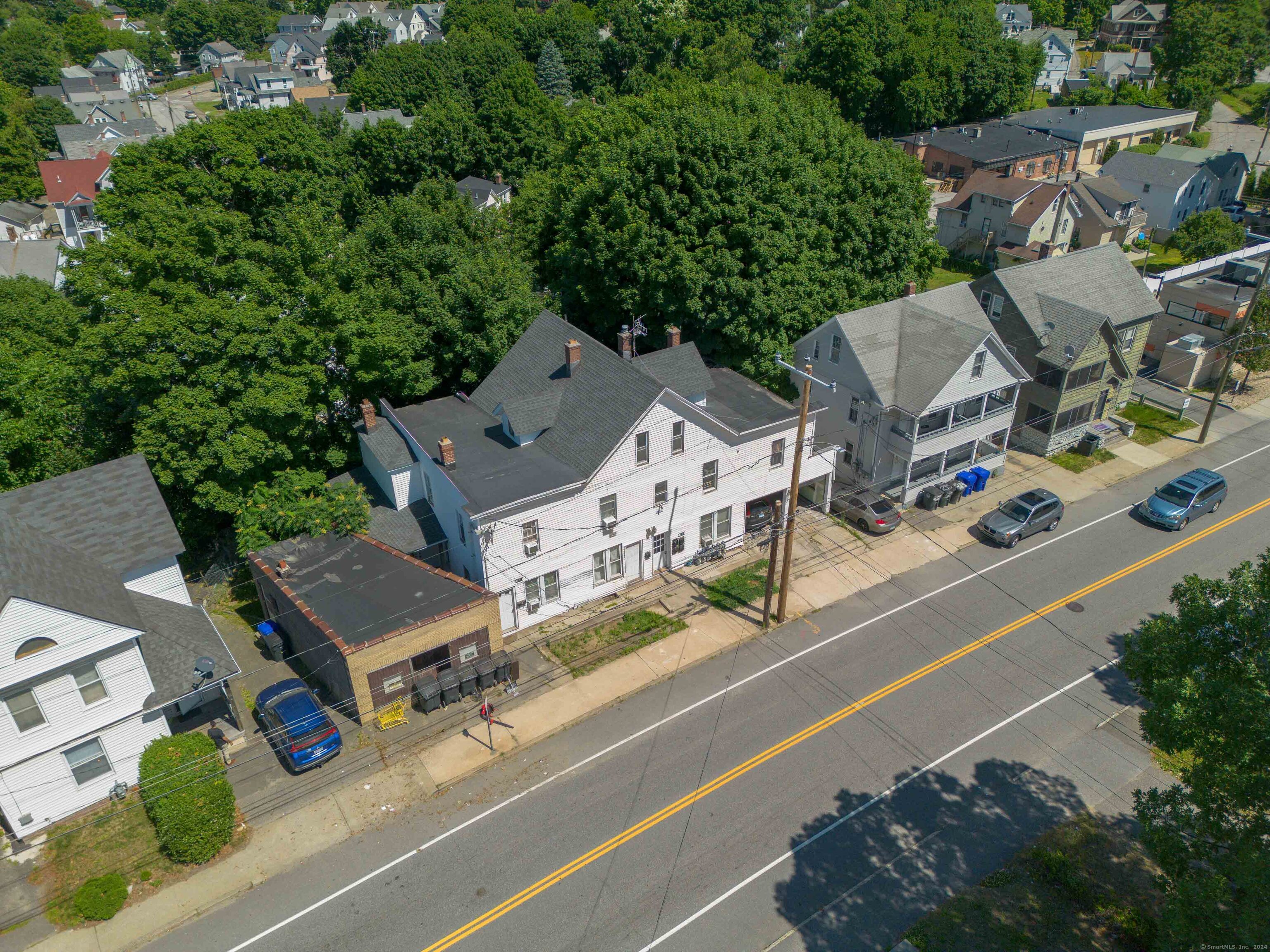 an aerial view of multiple houses with yard