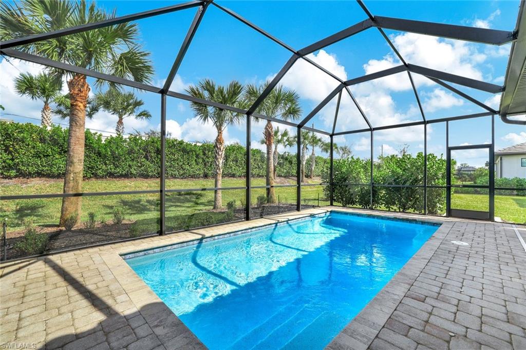 a view of swimming pool with a yard and sitting area