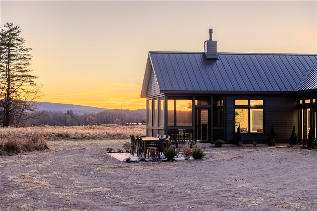 a view of a house with porch and sitting area