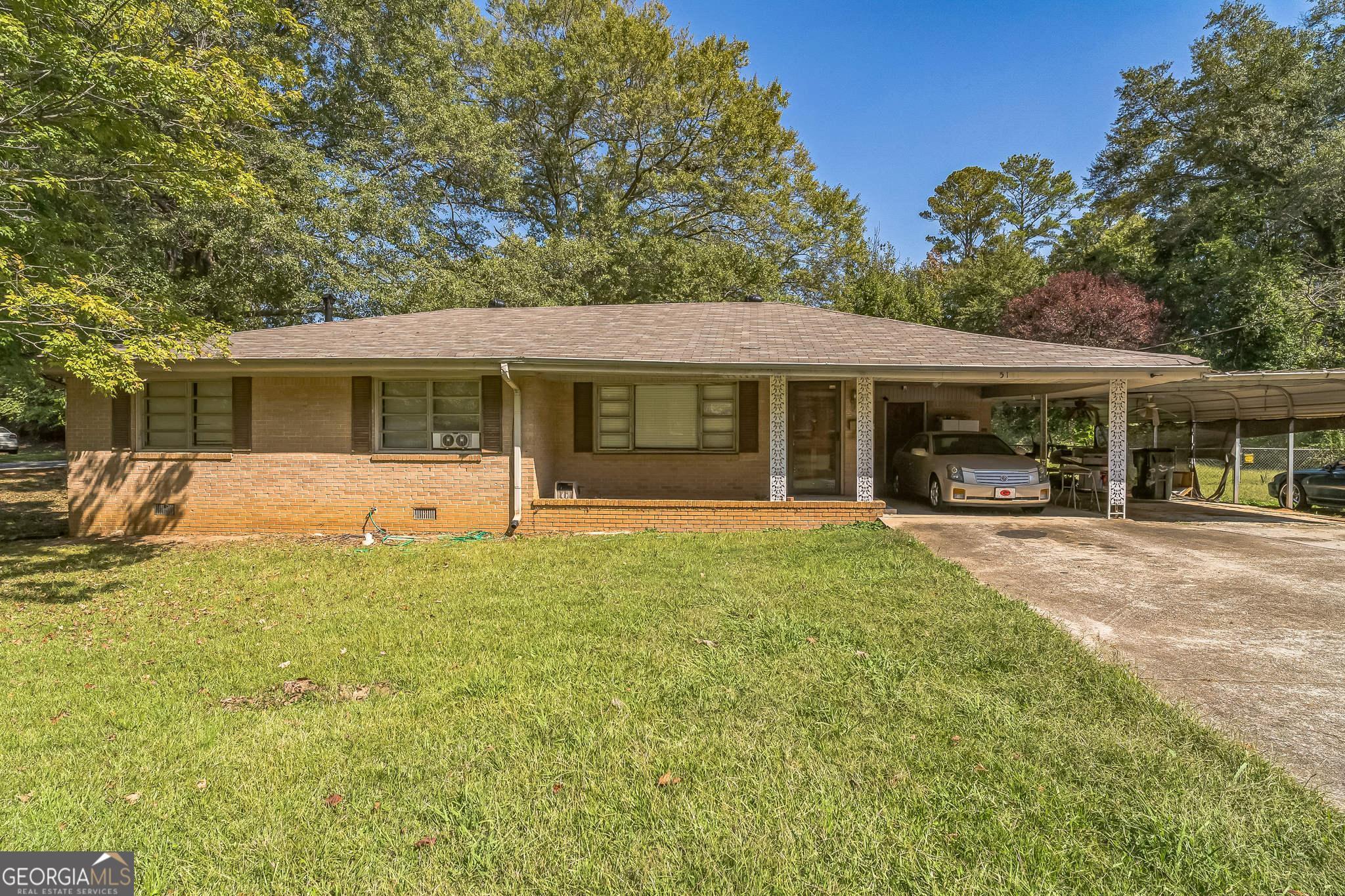 a view of a house with a backyard