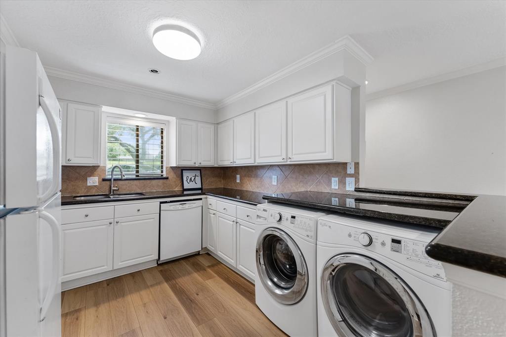 a kitchen that has a sink and a stove in it