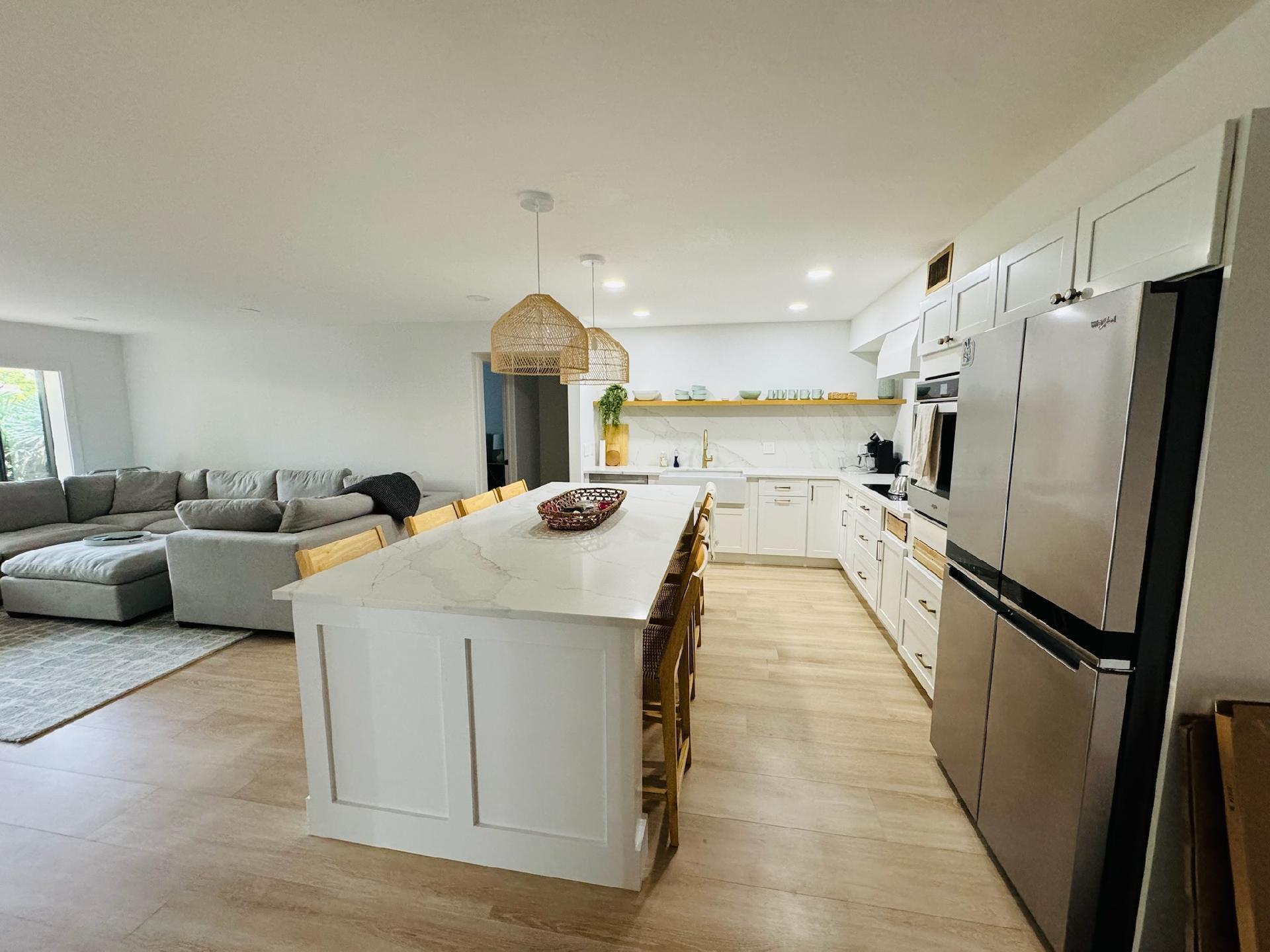 a view of a kitchen with a sink and refrigerator