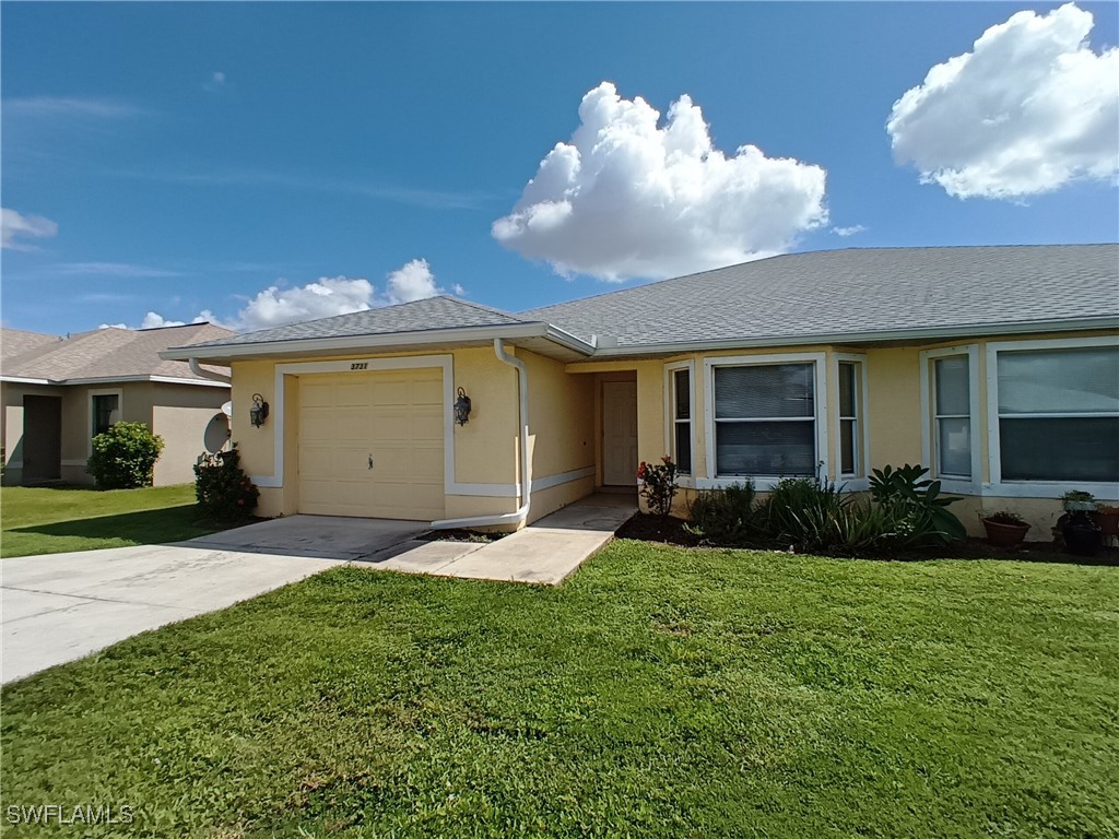 a front view of a house with a yard and garage