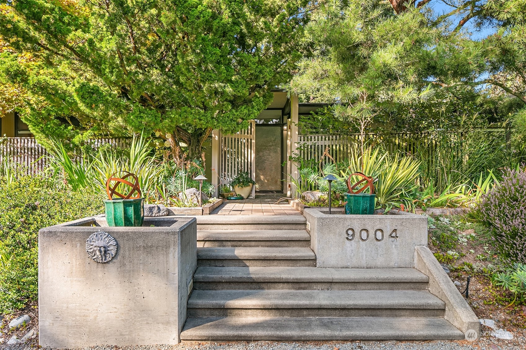 a view of fountain and potted plants