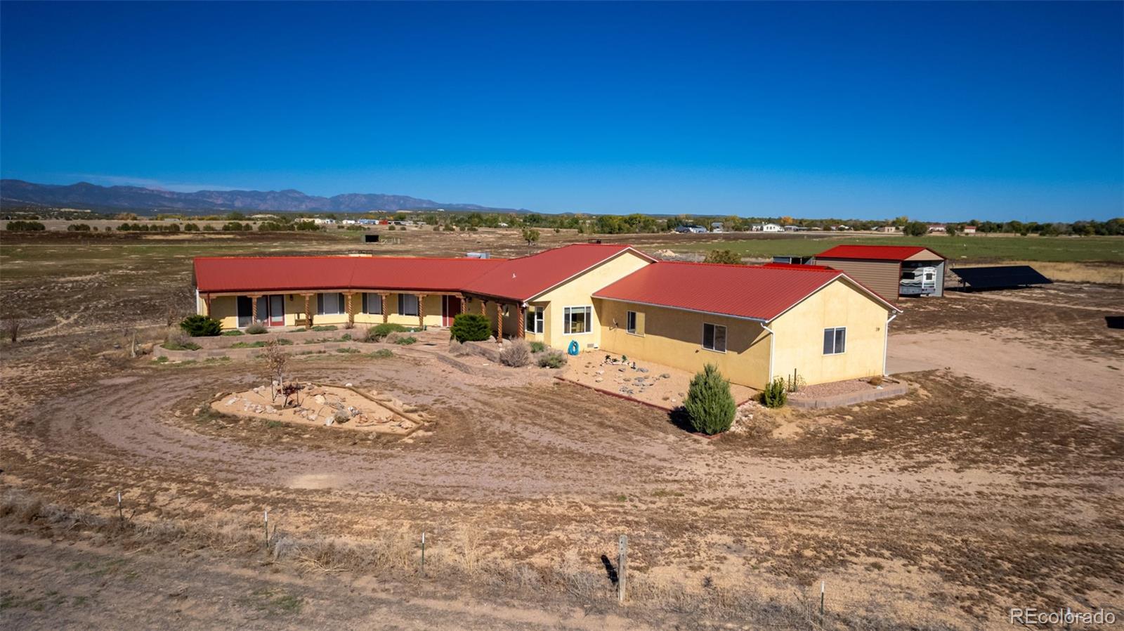 an aerial view of a house with a yard