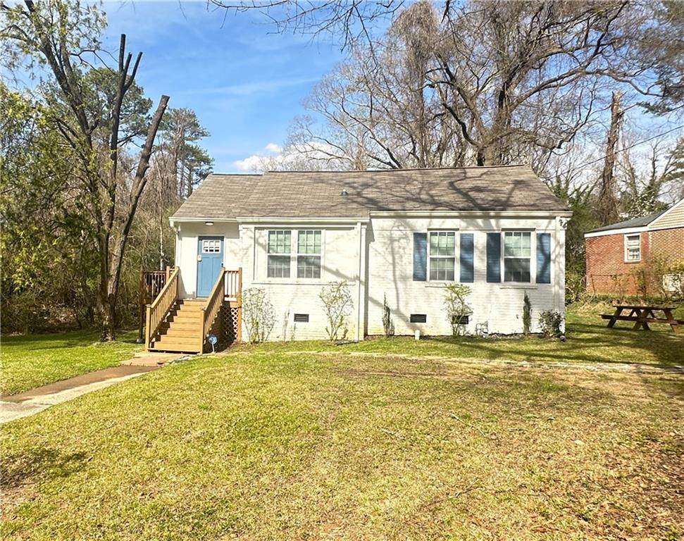 a view of a house with a big yard and large trees