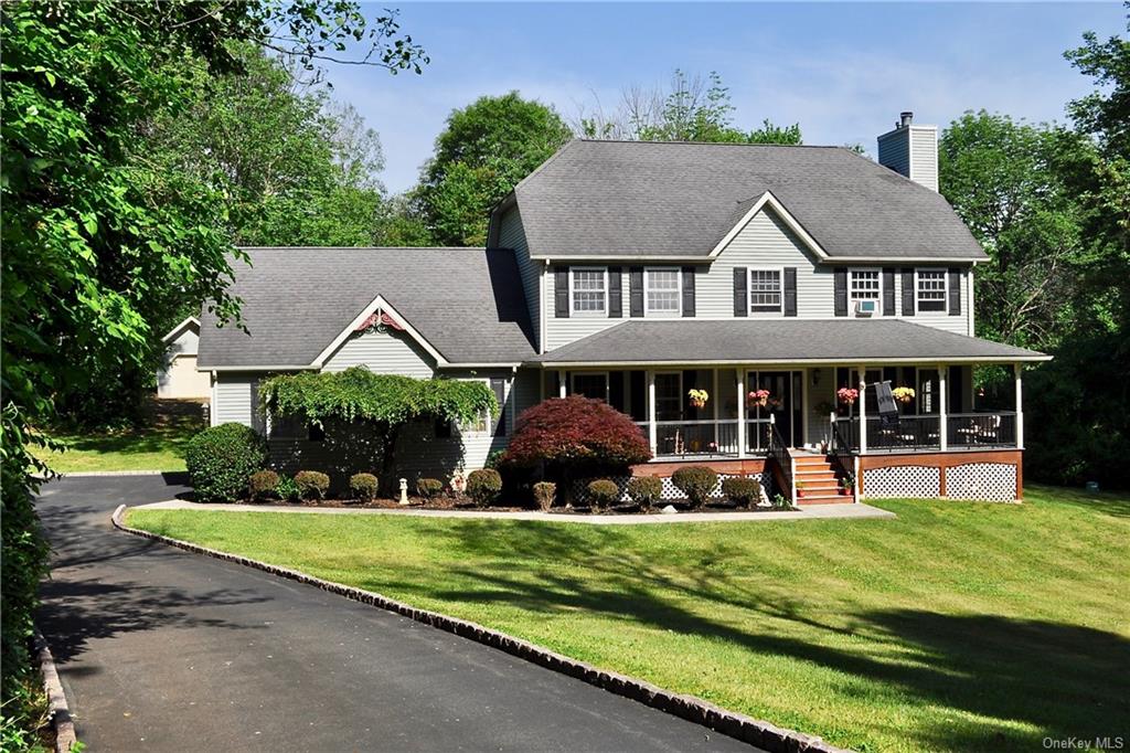 a view of a house with a yard and potted plants